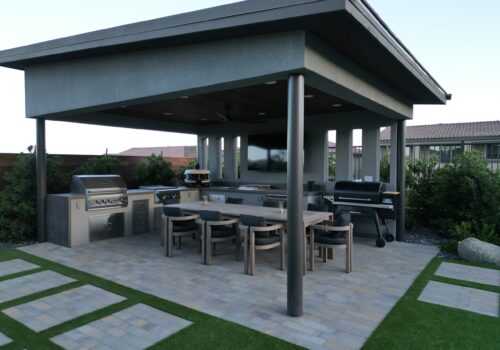 A patio with an outdoor grill and table