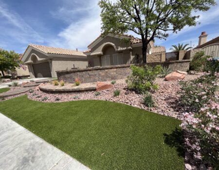 A house with a large lawn and landscaping.