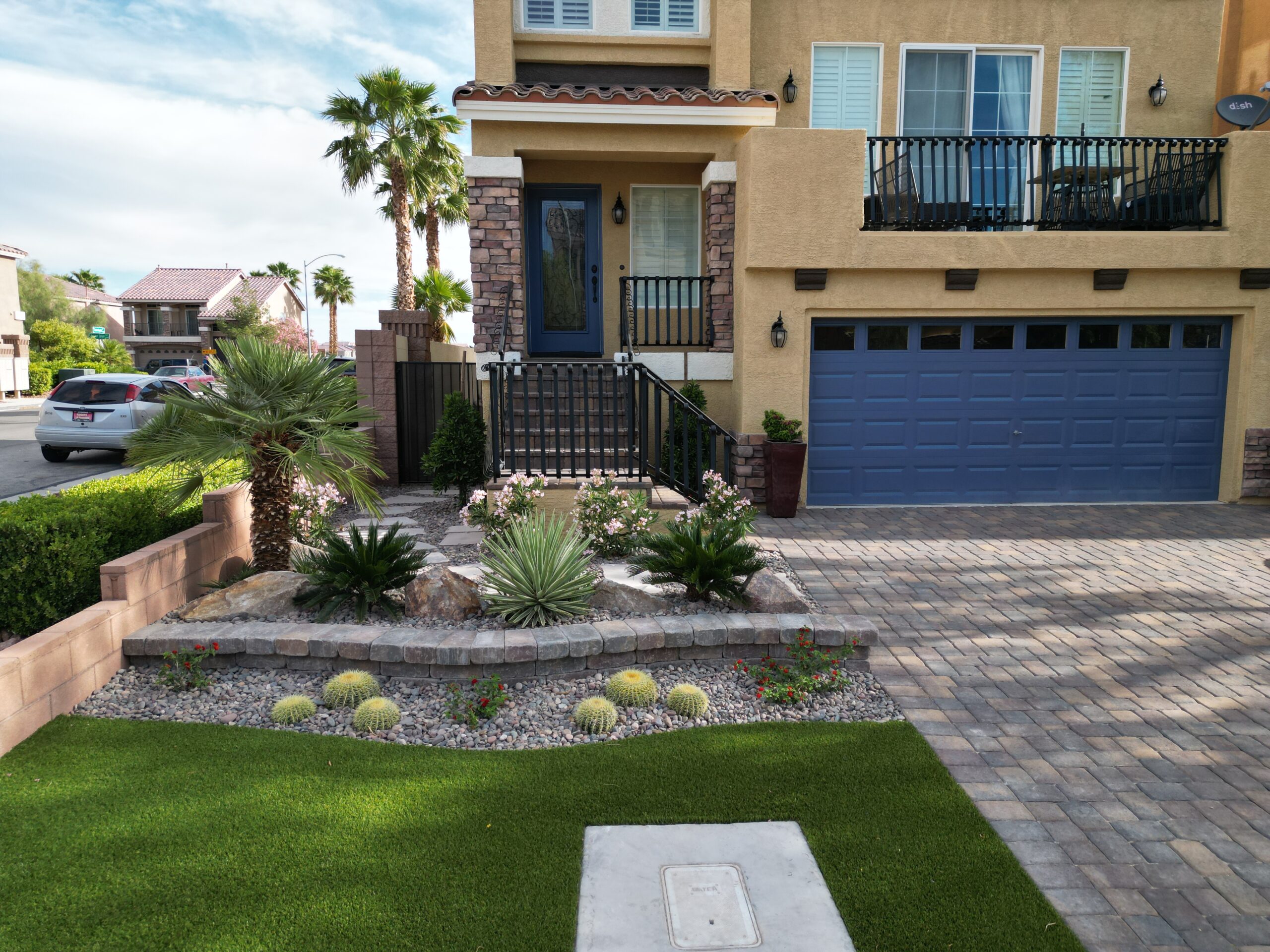 A house with a driveway and palm trees in the background. A house with a driveway and palm trees in the background.
