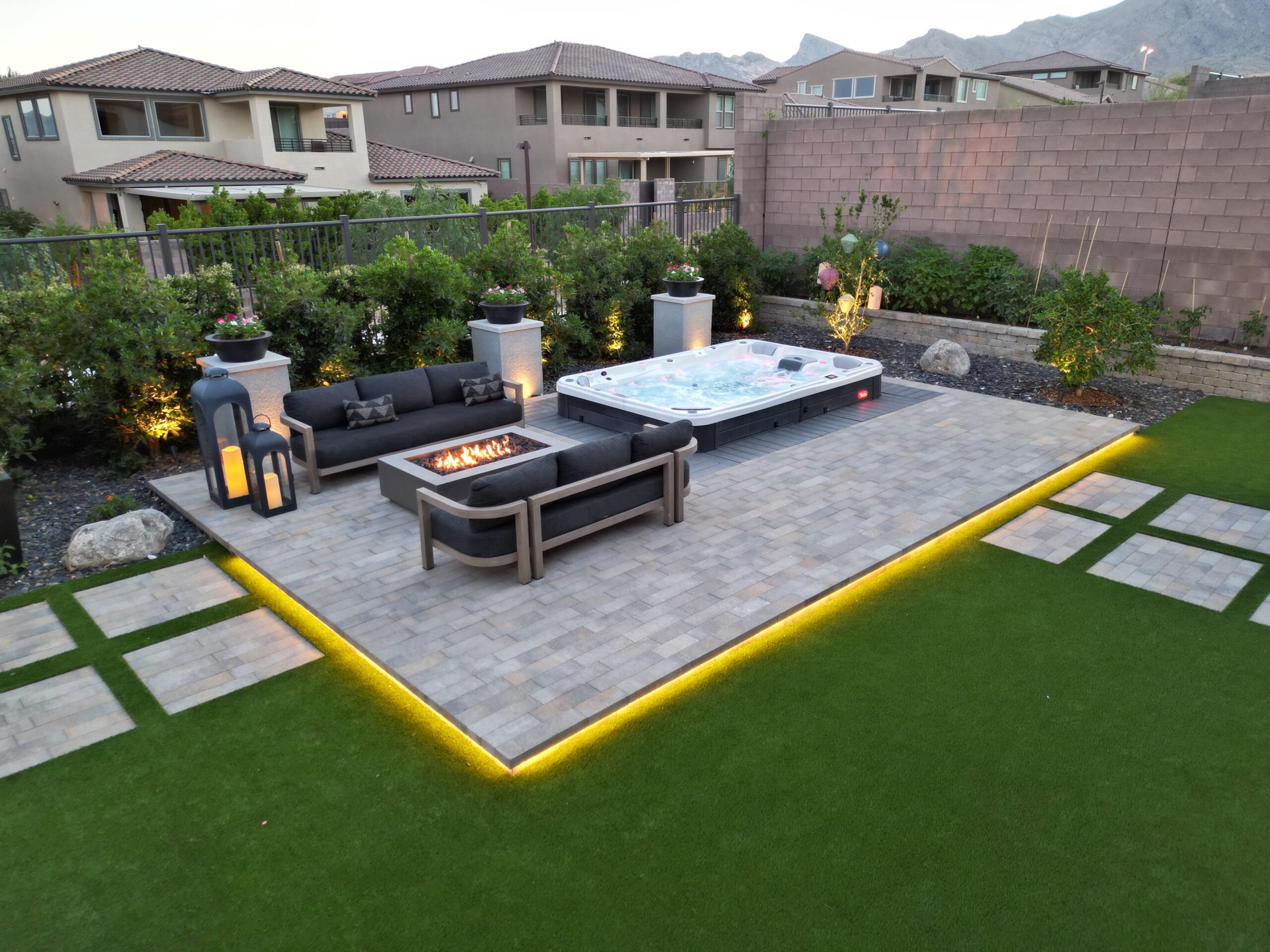 A backyard with a hot tub and fire pit. A backyard with a hot tub and fire pit.