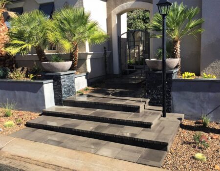 A front entrance with steps and planters.
